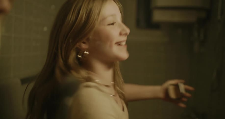 Happy girl dances in the bathroom waiting for a friend to apply makeup on her