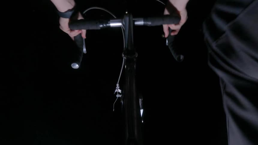 A man is riding his bike at night