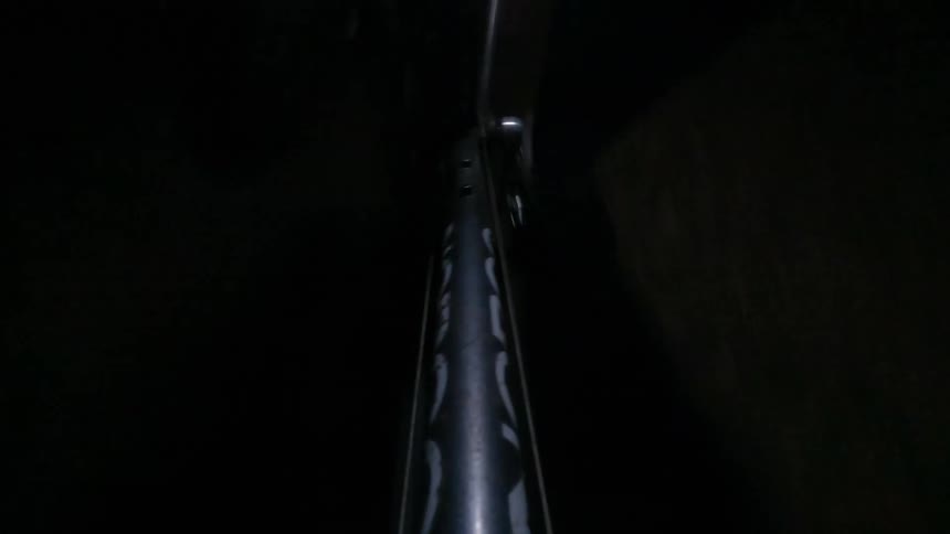Closeup of a persons feet pedaling on a bike at night