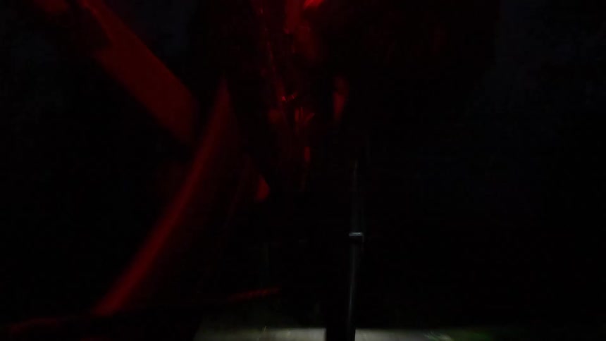 A person riding a bicycle outdoors at night