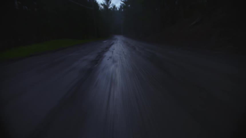 A person races their bike on the dirt trail