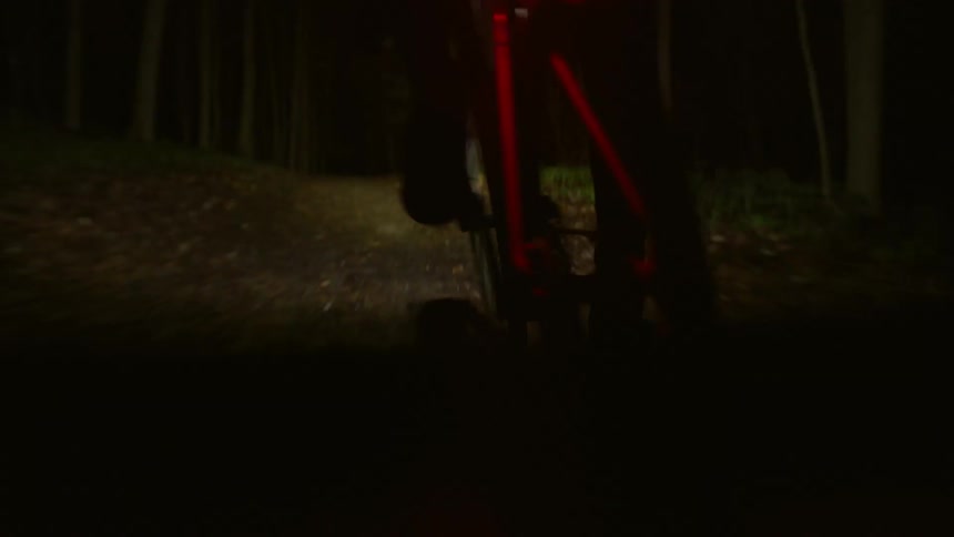 A clip of a rider riding a bicycle in the night