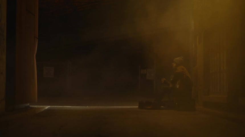 A person sitting on a foggy alley playing acoustic guitar at night
