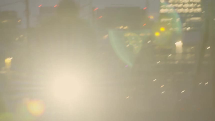 Person riding a bicycle on a street at night in a metropolis