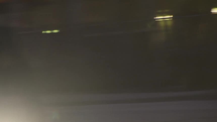 A man rides a bicycle in a city