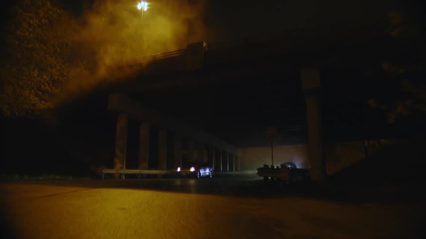 A person riding a motorcycle running away from police cars