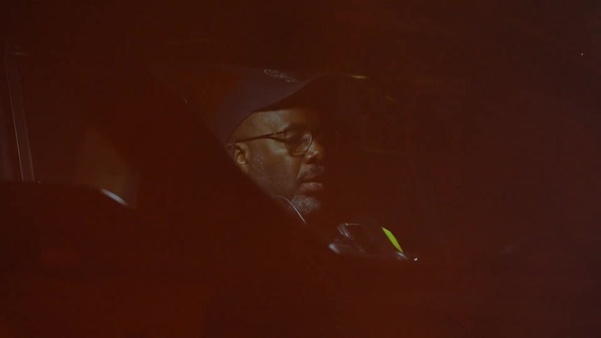 Man inside a vehicle with the interior light on at night