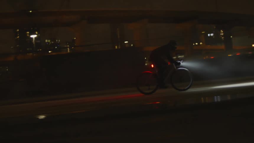 A man is racing his bike in the city