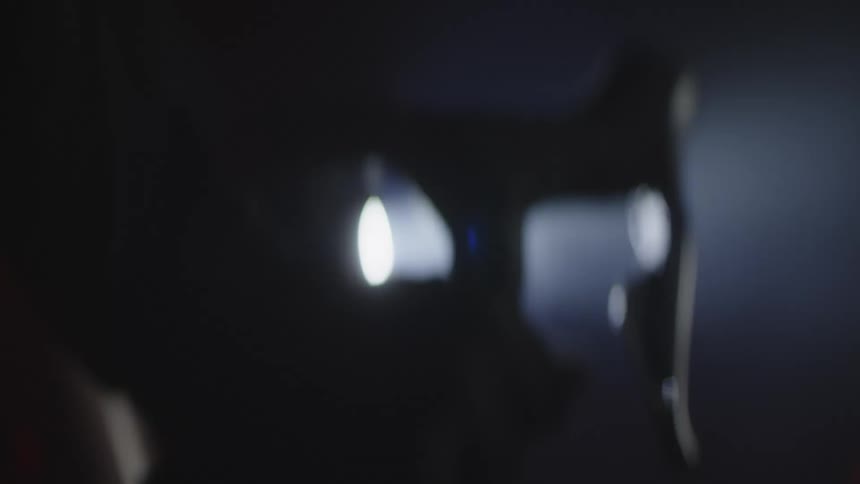 A person rides a bike through night fog