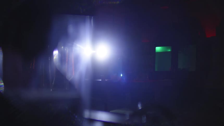 A spy walking in a dark house with a flashlight in his hands