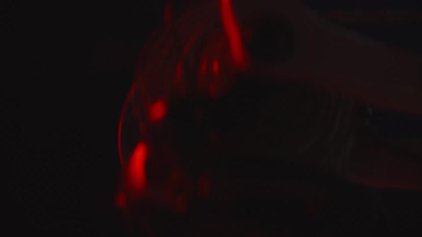 Closeup of a persons feet pedaling a bicycle quickly at night