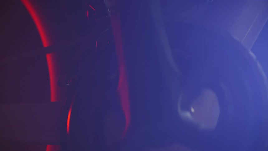 Closeup of a bicycle pedal with a person in motion at night