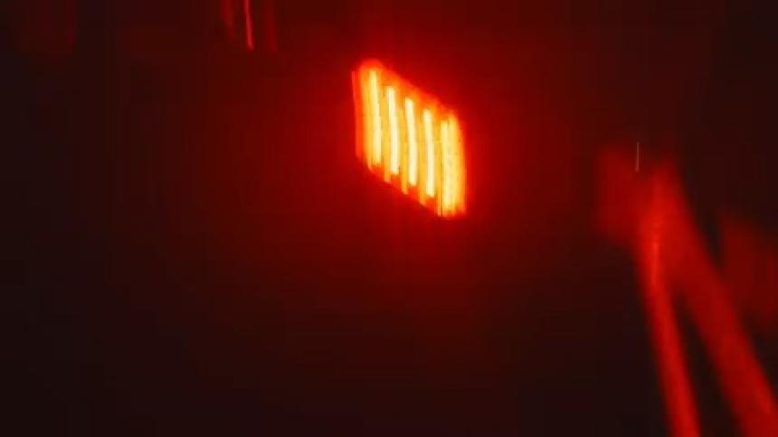 Man riding a bicycle at high speed at night