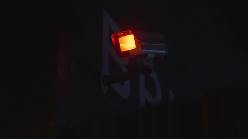 Orange light on a camera fixed on the wall