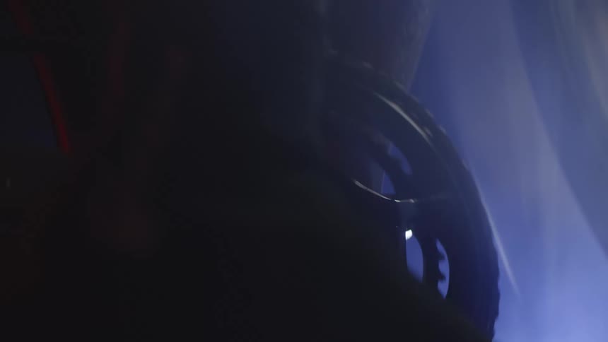 Closeup of a bike chain with a person pedaling at night