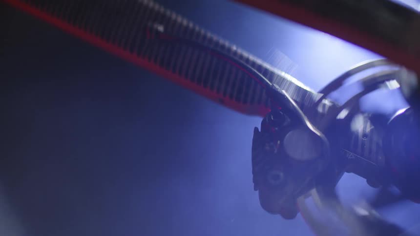Close up of the spinning gears of a bicycle riding at night