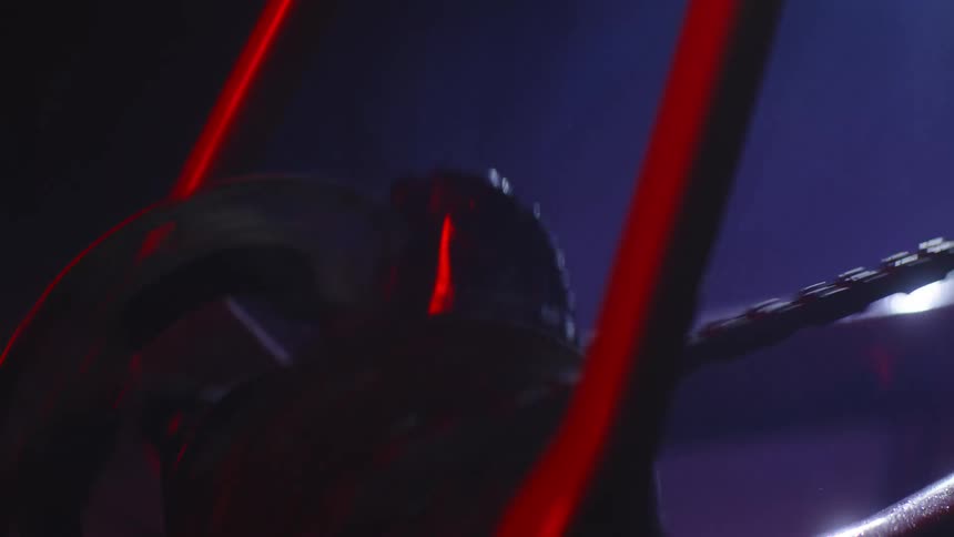 A person is riding his bicycle at night