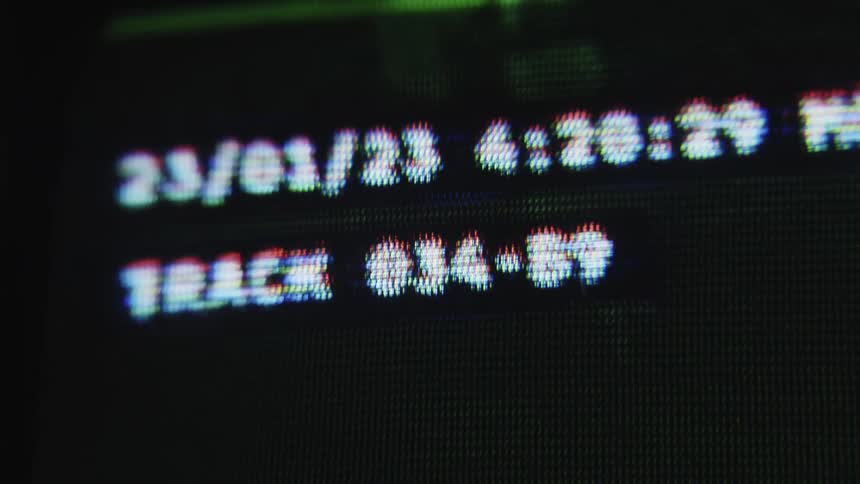 The monitor shows camera footage of someone riding off on a bicycle