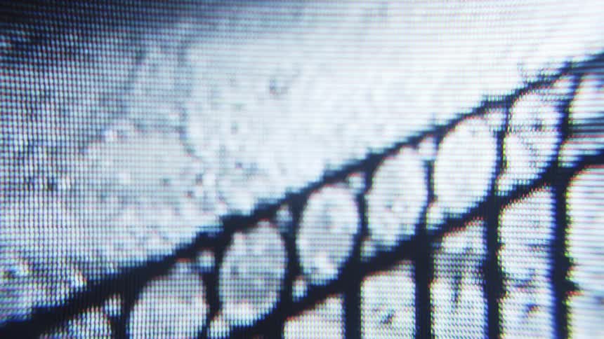 Close up on a screen showing a cyclist driving on a street at night