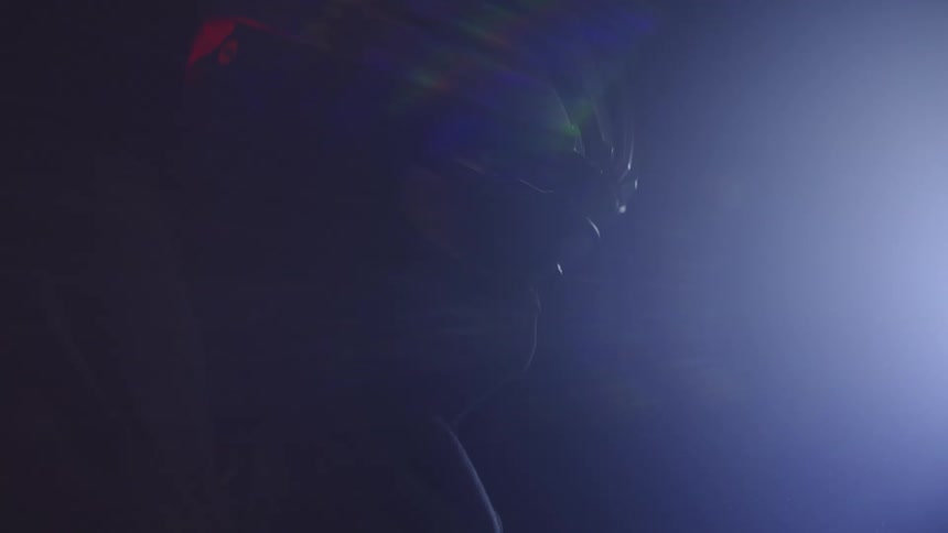 A man is riding his bike at night