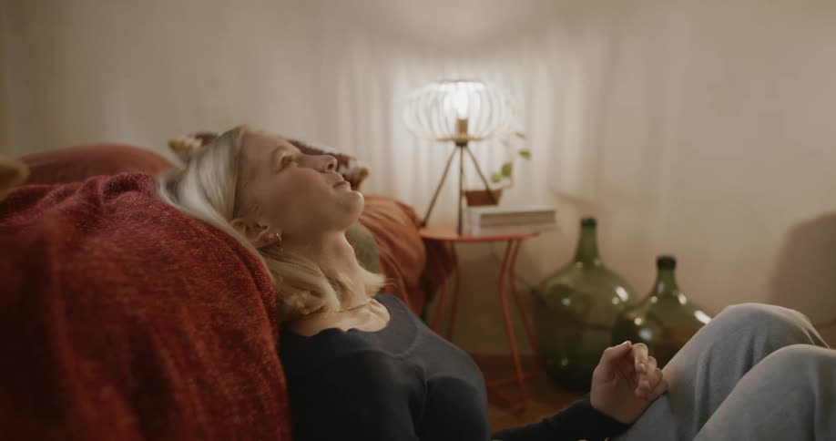 A woman looks at her phone and laughs