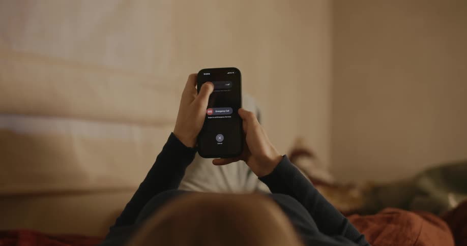Woman lying on the bed uses iphone smartphone