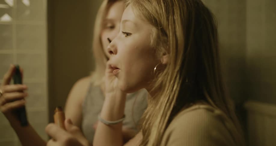 Teenagers are putting on makeup in the bathroom