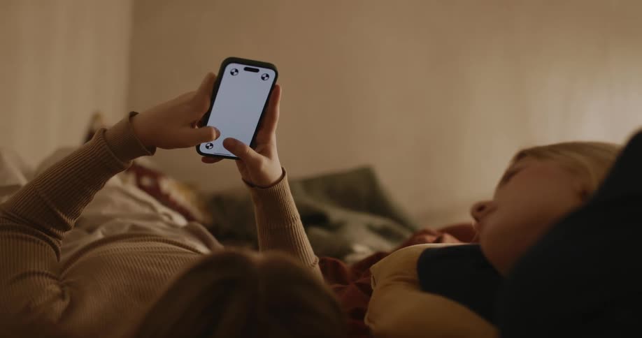 Two teenagers swipe on the cell phone
