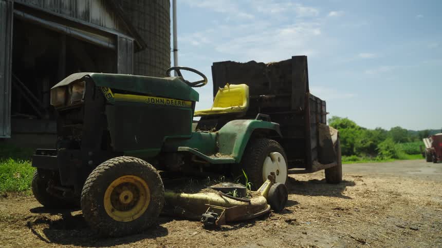 Agriculture tractor parked in front of a ranch