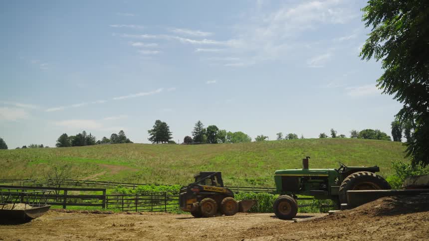 Person drives a farm machinery on a sunny day