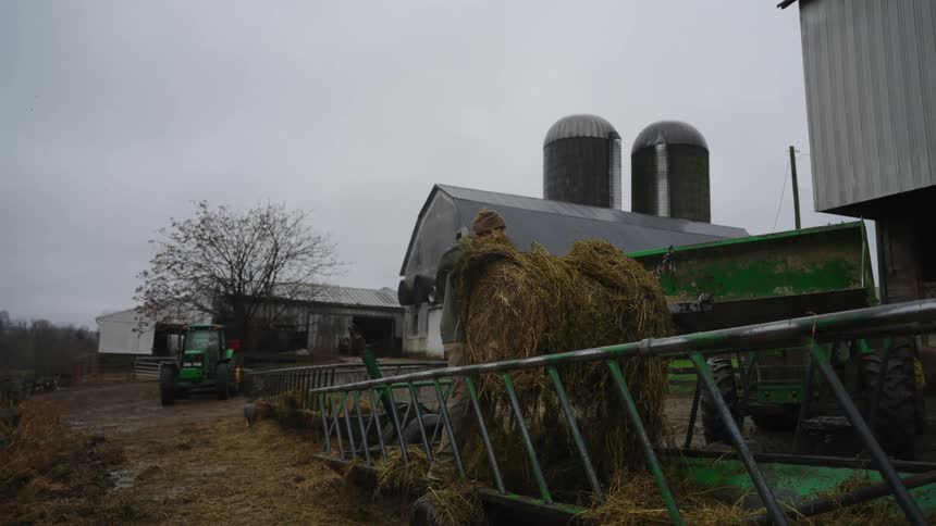 A man is moving hay on the farm