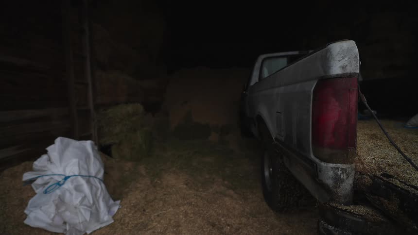 Truck inside a ranch full of grass