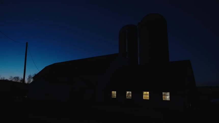 Silhouette of a rural house at night