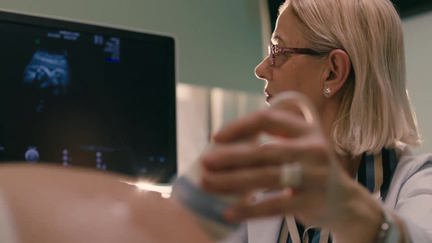 Doctor performing ultrasound on a pregnant woman