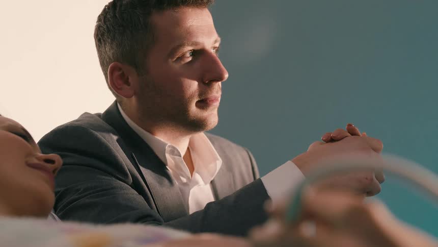 A healthcare professional is performing an ultrasound on a pregnant woman