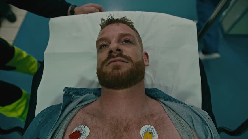 Portrait of a patient on a hospital stretcher waking up
