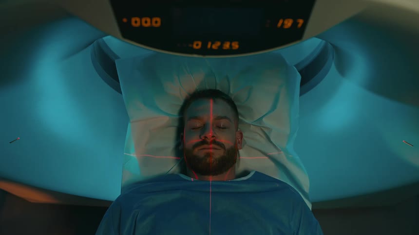 A patient passing through a ct scanner in the clinc