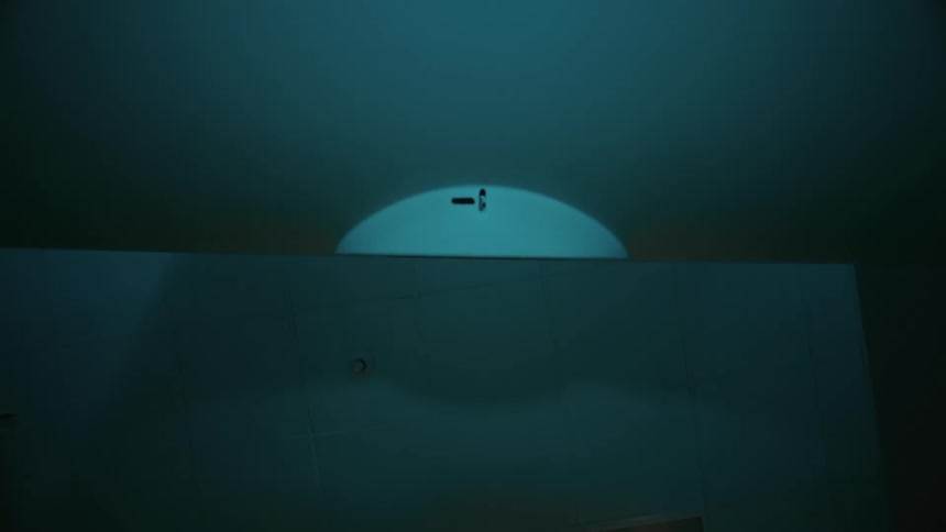Sliding on the interior of a running ct scan in a dimly lit room