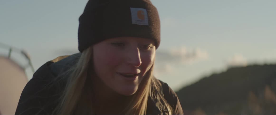 Portrait of a young blonde woman talking in a natural environment