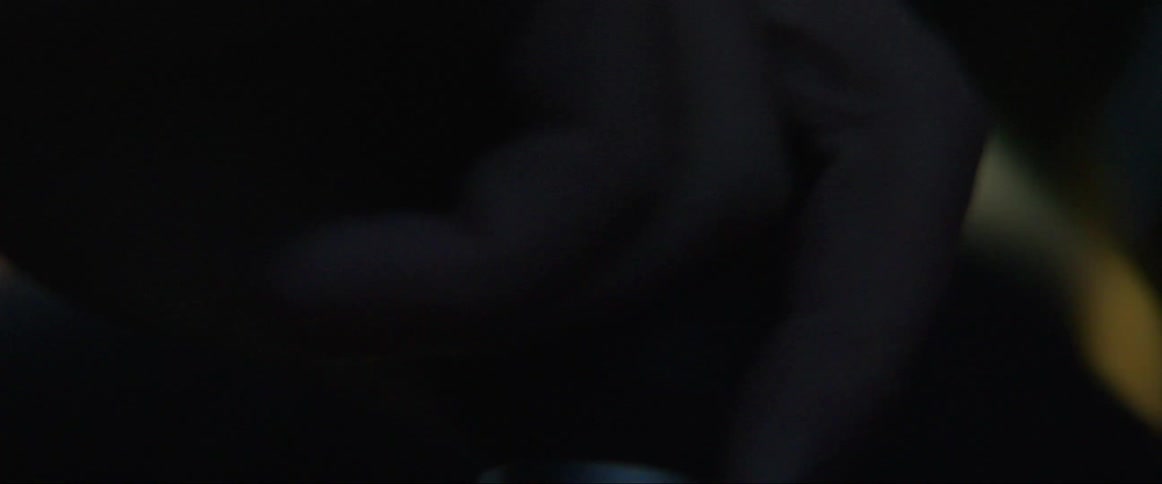 Hand being placed on the gearshift of a car