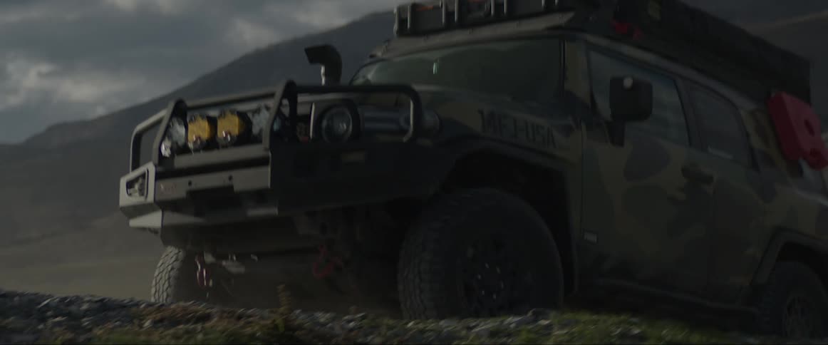 Adventure car climbing a hill and a half in a natural environment