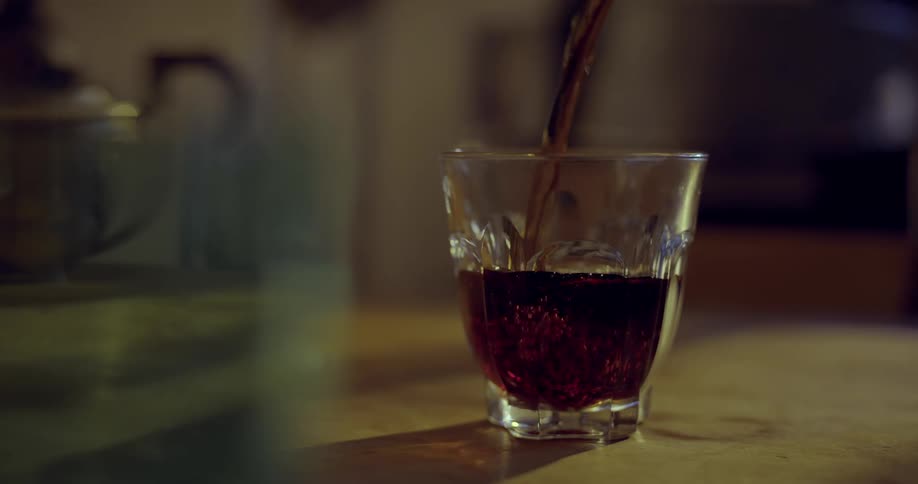 Coffee being poured into a  glass