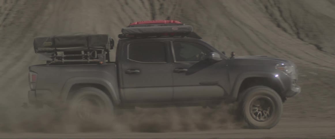 An atv driving through a desert dirt road