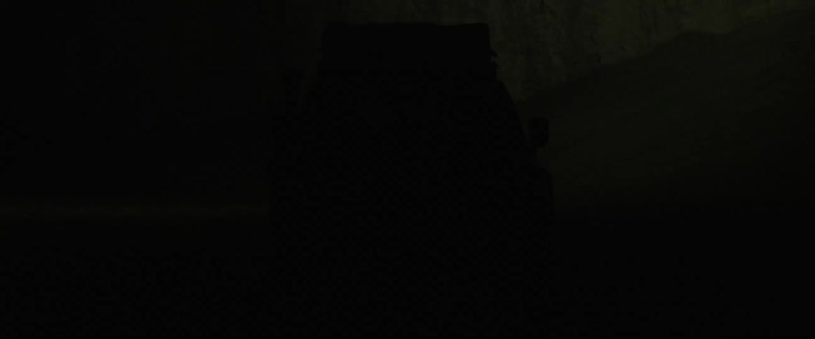 Sports truck turning on its lights in the pitch black and foggy