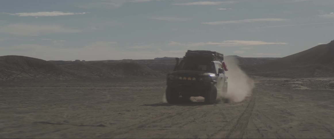 Jeep passing at high speed across the desert floor