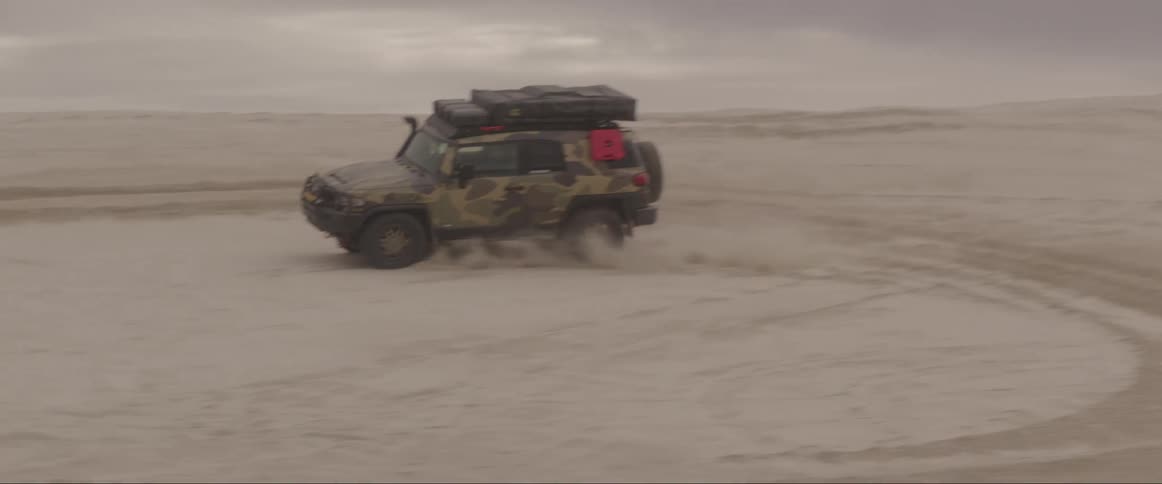 Vehicle moving fast on a sandy road at daytime