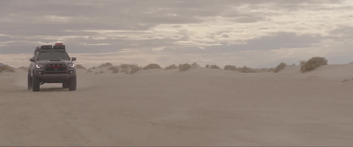 Cars speeding in the desert during sunset
