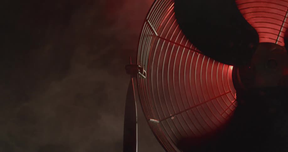 A fan blade rotates as a red light illuminates