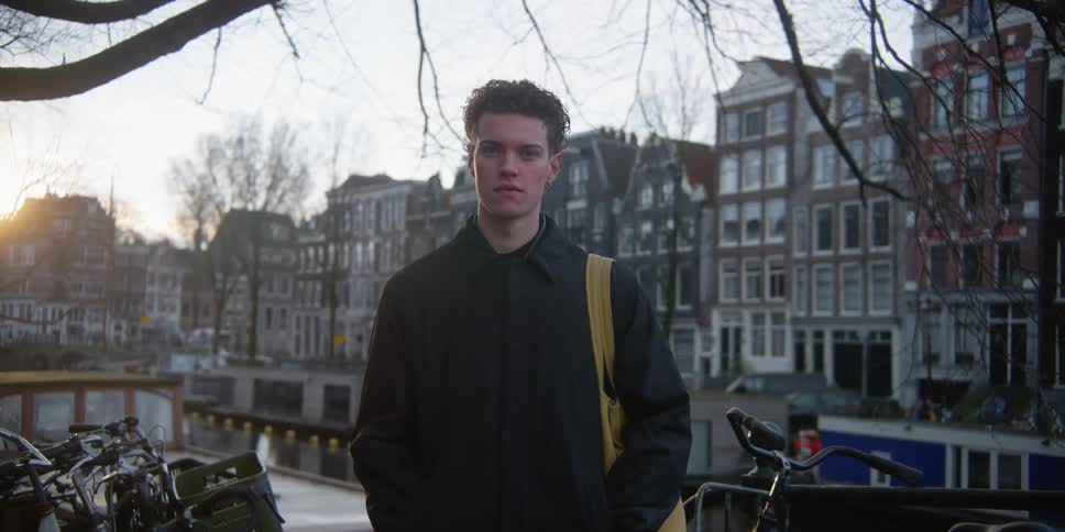 A boy standing on a deserted city street