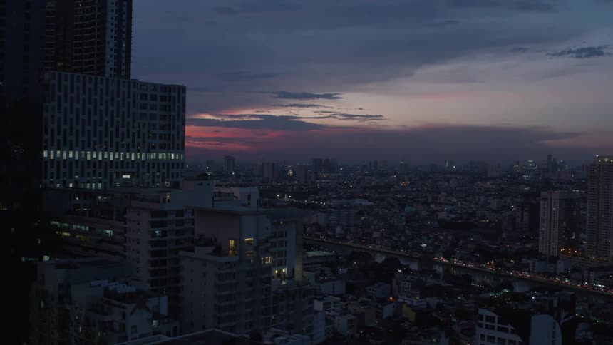 Panorama of a metropolitan city with a skyscraper and a purple sky